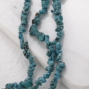 Macro shot of irregular turquoise stone beads with natural matrix for DIY jewelry