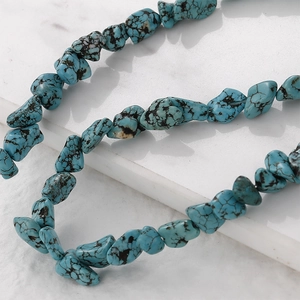Close-up of irregular natural turquoise stones with black veins for DIY jewelry making
