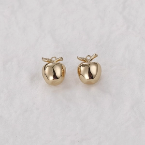Close-up of polished 14k gold-filled 3D apple charms for DIY jewelry making