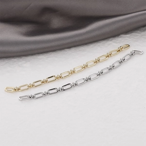 Detail of 14k gold-filled and silver rectangle link chains on silk texture background