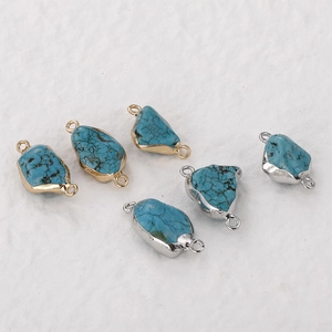 Detail view of 6 turquoise stone connectors with gold and silver plated metal frames