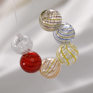 Set of 6 vintage colorful spiral glass beads for DIY jewelry making on silk background
