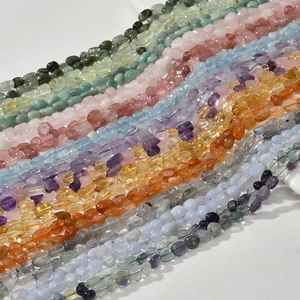 Macro view of natural multi-colored irregular semi-precious stone beads on white background