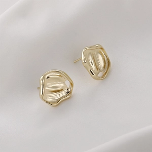 Minimalist 14K gold plated irregular pleated earrings with hollow details on white fabric