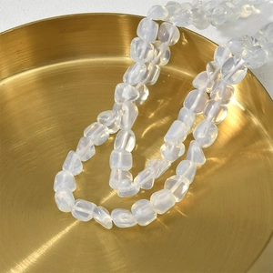 Detail of 5-8mm natural moonstone beads in a gold tray for DIY jewelry making