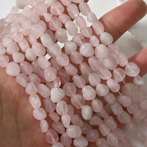 Macro detail of irregular 5-10mm rose quartz beads for DIY jewelry making