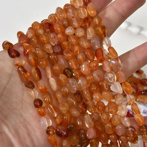 Macro detail of irregular polished red agate beads for DIY jewelry making crafts