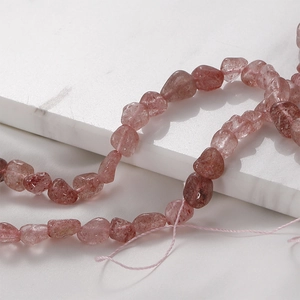 Macro detail of irregular strawberry quartz chips with natural crystal textures for jewelry DIY