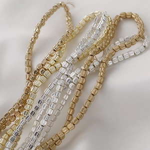 Macro shot of 4mm faceted pumpkin beads in gold, silver, and bronze for jewelry making