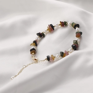 Handmade bracelet with natural stones, freshwater pearls and gold beads on white silk