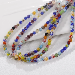 Macro detail of colorful millefiori glass beads with intricate floral patterns for DIY jewelry