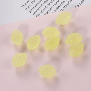 Translucent yellow resin lemon charms for DIY jewelry making on a pastel background