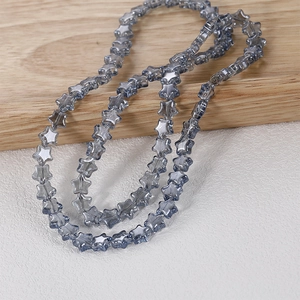 Detailed view of 8mm grey-blue translucent star-shaped crystal beads for DIY jewelry