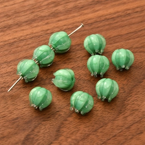 Macro detail of green bellflower glass beads with jade-like texture for DIY jewelry making