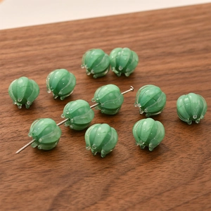 Macro shot of lily of the valley glass beads with translucent green marble texture