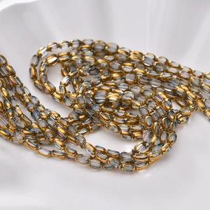 Macro detail of oval faceted crystal glass beads with gold plating for DIY jewelry