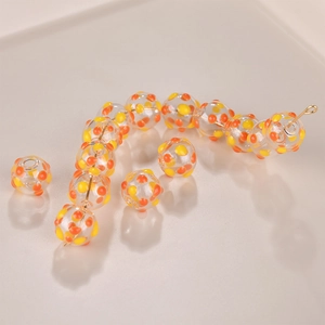 Handmade hollow glass beads with yellow and orange dots for DIY jewelry making
