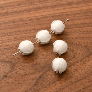 Macro view of white lily of the valley glass flower beads for DIY jewelry making