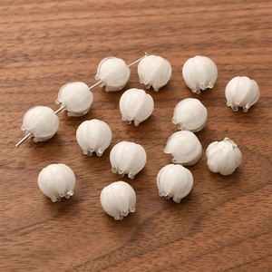 Detailed close-up of white lily of the valley glass beads for DIY jewelry making