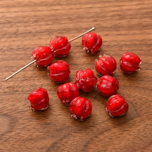 Macro shot of red lily of the valley glass beads for DIY jewelry making and crafts