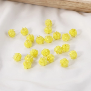 Close-up of lily of the valley glass flower beads on white fabric for DIY jewelry