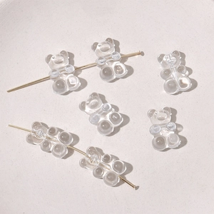 Makro-Detail von transparenten Gummibärchen-Perlen aus Harz auf einem Goldstift für DIY