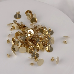 Detailed view of 14K gold plated flat head earring studs and backs jewelry components