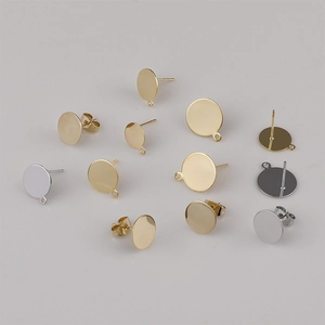 Detailed macro view of gold and silver plated flat stud earring bases with hanging loops