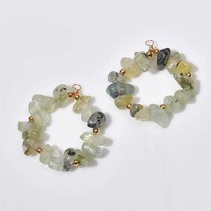 Detailed view of green gemstone hoop earrings with gold beads and wire-wrapped loop