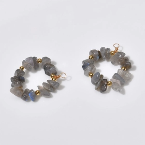 Detail of handmade gold wire-wrapped pendant with grey labradorite stones and gold beads