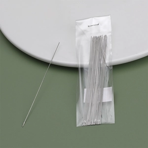 Detailed view of long big eye beading needles in clear packaging for DIY jewelry making
