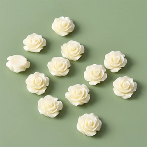 Detailed view of 12 cream white resin rose flower cabochons for DIY jewelry making
