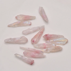 Detailed view of pale pink aura crystal points with iridescent coating for DIY jewelry