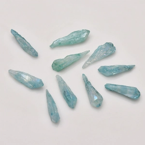 Detailed view of ten light blue iridescent agate crystal columns for DIY jewelry