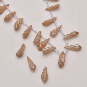 Macro shot of champagne crystal point beads showing natural texture for DIY jewelry making