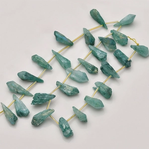 Close-up of irregular teal agate crystal pillars strung for DIY jewelry making