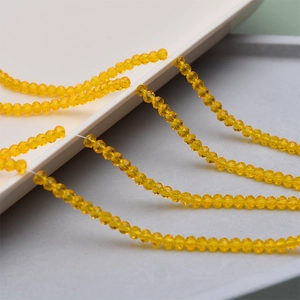 Macro shot of 4mm faceted yellow crystal glass beads for DIY jewelry making accessories