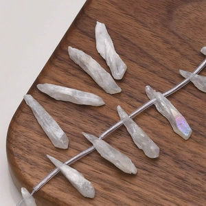Macro detail of irregular raw crystal pillars with rainbow luster on dark wood base