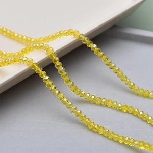 Macro shot of 4mm faceted yellow crystal glass beads for jewelry making projects