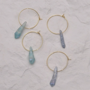 Golden hoop earrings with iridescent light blue and purple crystal point pendants