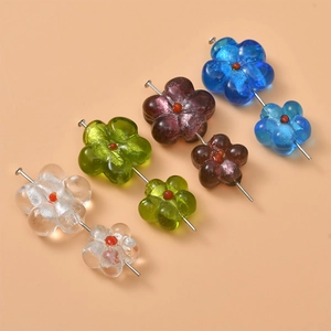 Detailed view of handmade glass flower beads in assorted colors with interior silver glitter