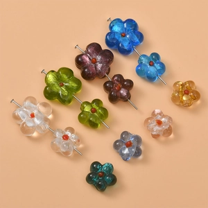 Macro shot of colorful glass flower beads for DIY jewelry making and crafting