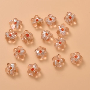 Detailed view of handmade orange glass flower beads with silver foil for DIY jewelry making