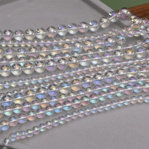 Macro detail of iridescent crystal beads in various sizes on a grey jewelry tray