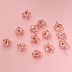 Detailed view of pink glass flower beads with orange center for DIY jewelry making