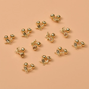 Detailed close-up of 14K gold plated cherry fruit pendants for DIY jewelry crafting