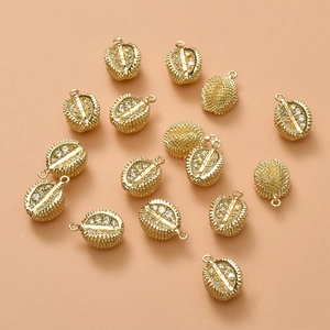 Macro shot of 14K gold plated durian pendants with sparkling crystal rhinestones for DIY