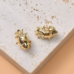 Macro detail of 14K gold plated insect-shaped jewelry pendants with sparkling zircon