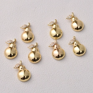 Macro view of 14K gold plated pear pendants with micro-pave cubic zirconia leaf details