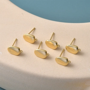 Detail of 14K gold plated bean stud earring findings with hanging loops for DIY jewelry